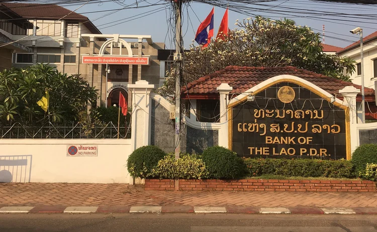 Bank of the Lao PDR front entrance sign and flags
