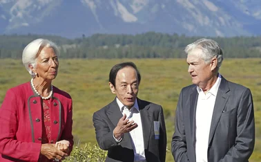 Christine Lagarde, Kazuo Ueda and Jerome Powell standing in front of the Jackson Hole mountains