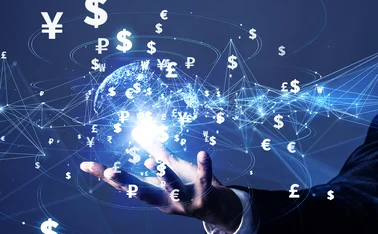 A businessperson’s hand hovers underneath a digital rendering of the earth, superimposed by international currency symbols connected by lines to show payment systems