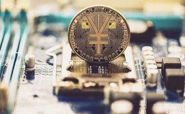 A yuan coin on a computer motherboard