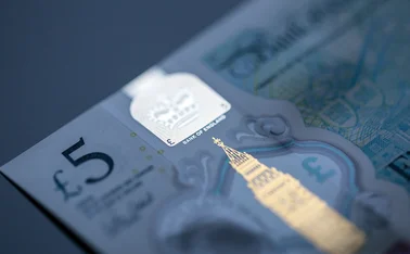 Five pound note highlighting Bank of England text