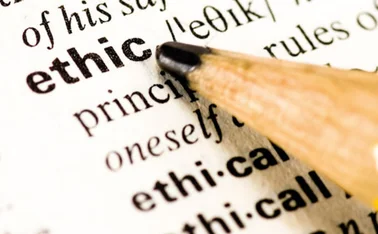 A pencil pointing at the word 'ethic' in a dictionary