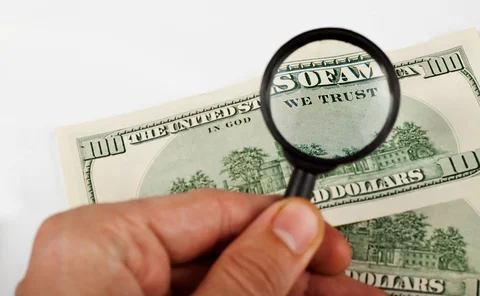 Dollar and magnifying glass