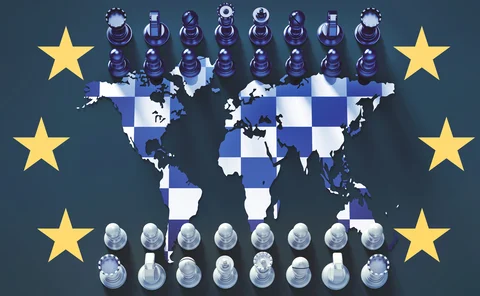 Chessboard against global map surrounded by EU stars