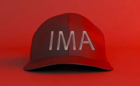 A red ‘maga-style’ baseball cap has the letters IMA written on it