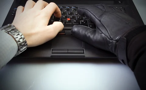 Cyber fraud and computer crime with hacker and businessman hands hacking internet