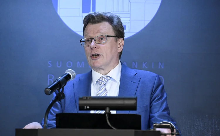 Tuomas Välimäki speaking at a lectern