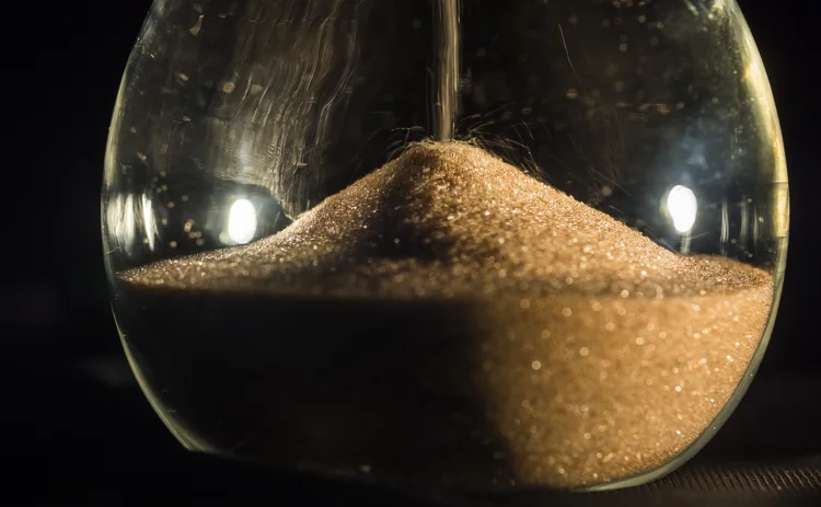 Close-up of sand falling in an hourglass
