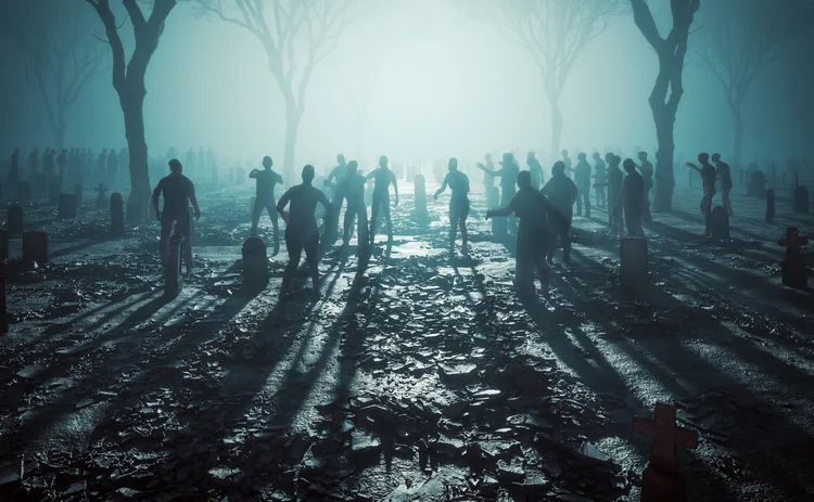 Zombies lurching through a graveyard