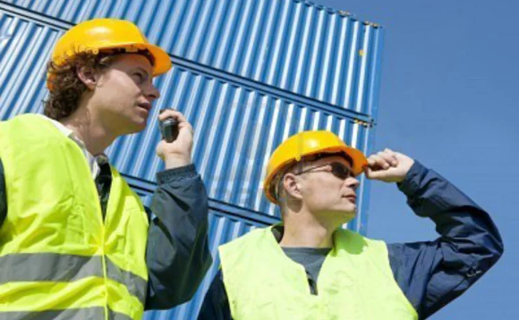 7065201-two-dock-workers-in-safety-clothing-supervising-and-giving-instructions-using-a-walkie-talkie
