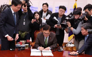 Woo Won Shik, speaker of the South Korean parliament, signs the resolution to impeach president Yoon Suk Yeol