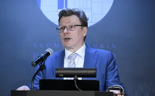 Tuomas Välimäki speaking at a lectern