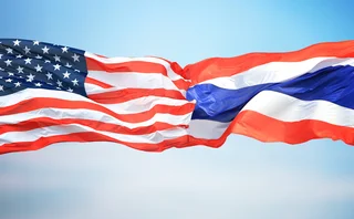 Flags of USA and Thailand facing each other