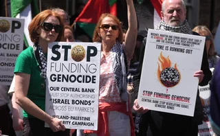 Ireland-Palestine Solidarity Campaign people holding placards reading ‘stop funding genocide’