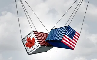 A shipping container painted with the Canadian flag clashing with one painted with the US flag