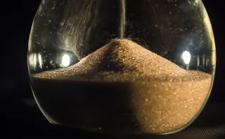 Close-up of sand falling in an hourglass
