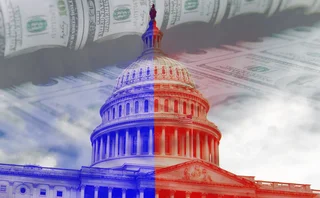US Capitol building over laid with banknotes and red, white and blue colours