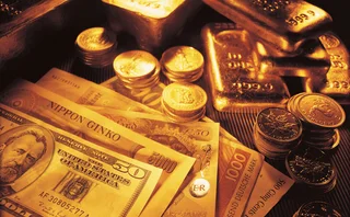 Gold bars and banknotes and coins of several world currencies