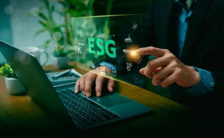 ESG letters over a man sitting in front of a screen