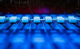 Mixing desk equalisers below a trading chart backdrop