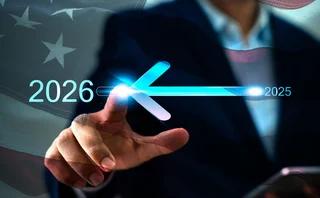 Abstract image of a man sliding a date from 2025 to 2026 with a US flag overlaid