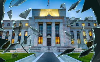 Federal Reserve building with shards of shattered glass around it