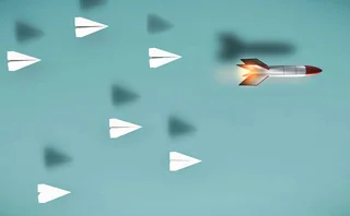 Paper planes fly on a blue background, but in the lead is a speeding rocket