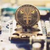 A yuan coin on a computer motherboard