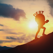 Man carrying the word ‘debt’ up a hill on his back