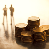 Small figures looking at piles of coins