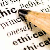 A pencil pointing at the word 'ethic' in a dictionary